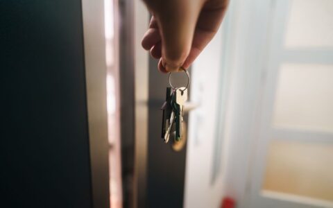 Close-up of a hand holding keys, symbolizing home ownership or rental entry.