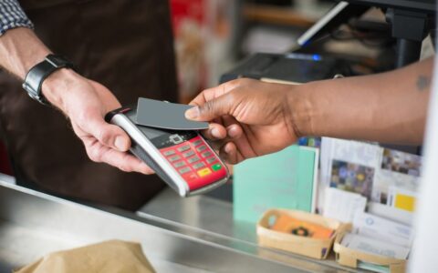 Close-up of a contactless payment transaction in a retail setting.