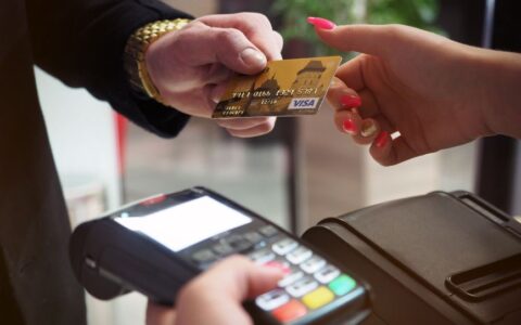 Close-up of a credit card payment being processed at a POS terminal.